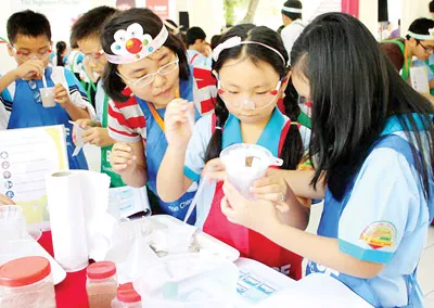 Học sinh Trường Tiểu học Lê Ngọc Hân, quận 1, TPHCM thí nghiệm vui trong giờ ngoại khóa. Ảnh: T.L.