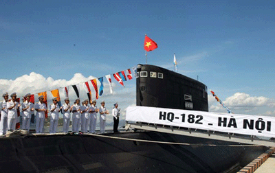 The national flag is raised during a ceremony held yesterday for the country's first two submarines at Cam Ranh Port in central coastal Khanh Hoa Province. (Photo: VNA)