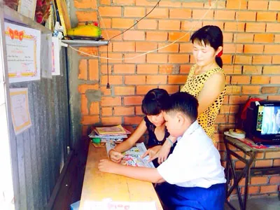 Chị Lê Thị Yến bên các con trong căn nhà do các đảng viên xã Tân Quý Tây đóng góp xây dựng.