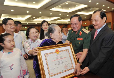 HCM City's Party Committee Secretary Le Thanh Hai awards the Heroic Vietnamese Mothers title to mother Quach Thi Hong. Deputy Standing Party Secretary of HCM City Vo Van Thuong congratulates mother Nguyen Thi Thiep at the ceremony. Vice State President Nguyen Thi Doan bestows the title “Heroic Vietnamese Mother” to mother Nguyen Thi Nam