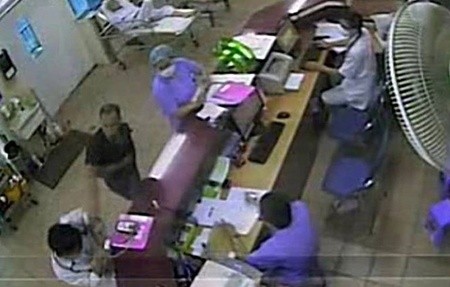 An image taken from the Bach Mai Hospital's CCTV shows a patient's relative (in black) attacking a doctor last week. Security at the hospital has been tightened to ensure safety for doctors, medical staff, patients and their relatives. — Bach Mai Hospital Courtesy Photo