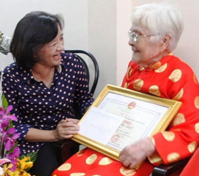 Mrs. Than Thi Thu wishes Mrs. Lam Thi Nang good health and long life (Photo:SGGP)