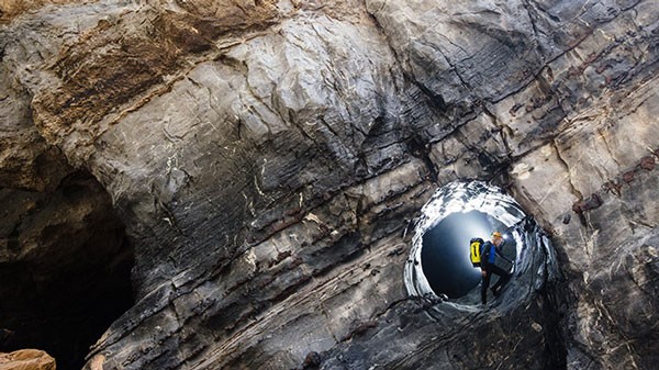 A circular hole on a wall in the cave (Photo: Ryal Deboodt) A stream in the end of the cave