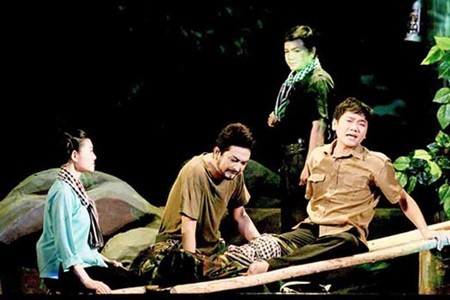 Setting the scene: A scene in Chien Binh, a cai luong play, featuring veteran soldiers and their postwar challenges, is being staged by the HCM City-based Tran Huu Trang Cai Luong Theatre. — Photo sggp.org.vn