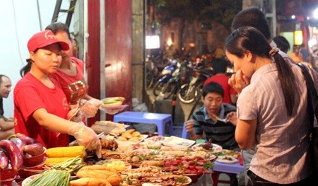 Street food in preparation in Hang Bong Street, Ha Noi. Most Vietnamese people don't pay attention to nutrition and have unbalanced meals. — VNS Photo Doan Tung