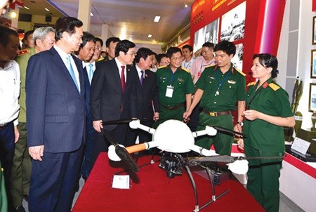 Prime Minister Nguyen Tan Dung has a close look at a modern unmanned aircraft model at the Ministry of Defence's display area at the exhibition. — VNA/VNS Photo