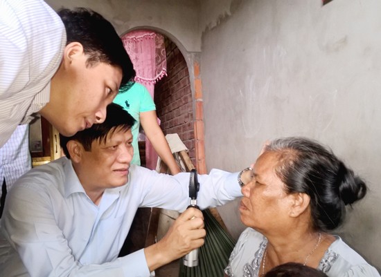 Deputy Health Minister Thanh Long is examining eye of a resident in Vinh Chau Town in Soc Trang Province (Photo SGGP)