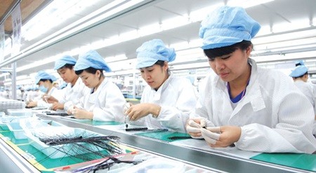 Blueco Vina JSC workers manufacture electronic devices in Hai Phong City's Trang Due Industrial Zone. The zone has attracted US$297 million in foreign direct investment (FDI) this year, raising the total registered capital here to $2.1 billion. (Photo: VNA/VNS)