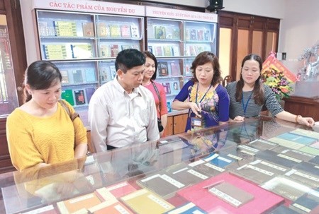 Visitors look at different versions of The Tale of Kieu exhibited at the Nguyen Du memorial house in Ha Tinh province. (Photo: VNA)
