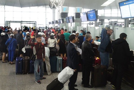 Passengers wait for their turns to complete procedures at Noi Bai International Airport in Ha Noi. The rate of delayed and postponed flights since July was 15-20 per cent. — VNS Photo Doan Tung