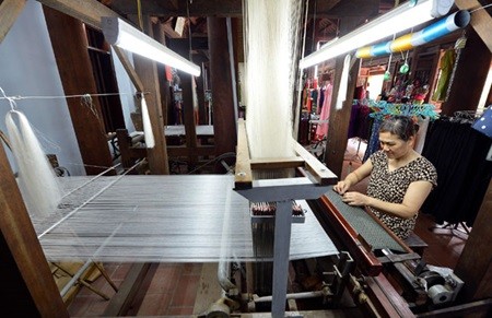 A silk weaver in Van Phuc Village works on a new design. (Photo: VNA/VNS)