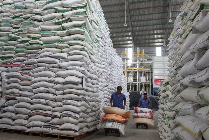 Workers of HCM City Food and Foodstuff company load rice for export.