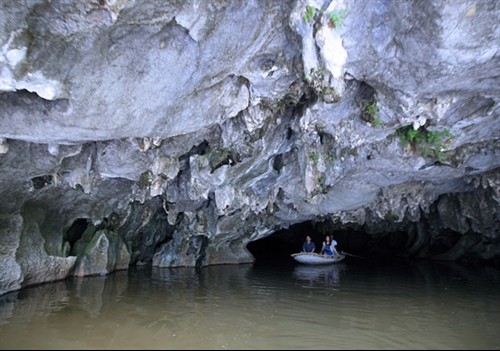 Tranquil: Tourists ride boats to discover Vân Long Natural Reserve which houses many caves with beautiful grottoes.