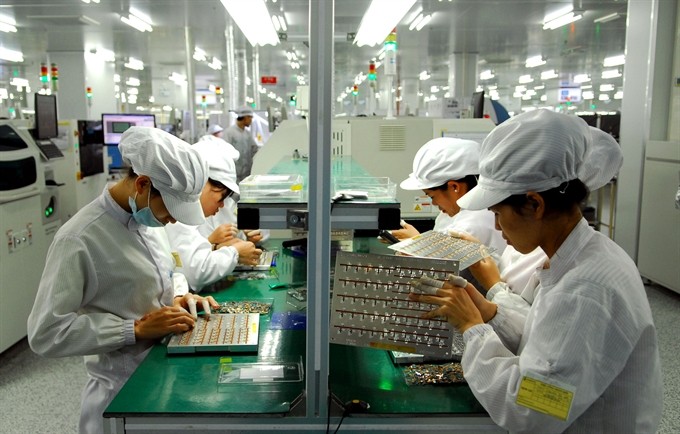 A production line for electronics spare parts at SYNOFEX Việt Nam Company in Hà Nôi’s Quang Minh Industrial Park. Fitch forecast Việt Nam’s GDP would rise by 6.2 per cent in 2016 thanks to the strong growth of several industries, including manufacturing and services. — VNA/VNS Photo Danh Lam