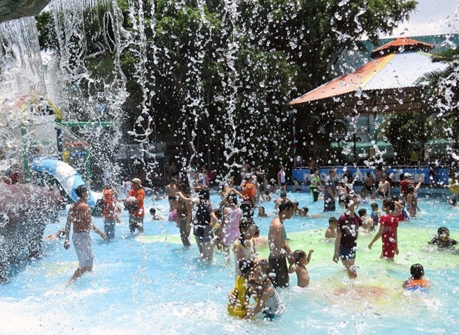 Children and their parents play at Dam Sen Park (Photo: VNA)
