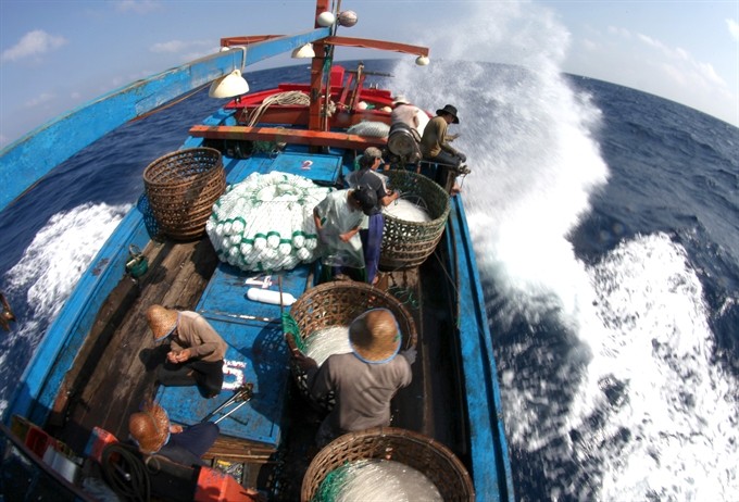 Fishermen on their vessel going fishing offshore. Việt Nam calls on all East Sea claimants to urgently join forces in tackling the environmental degradation offshore before it’s too late. (Photo: VNS)