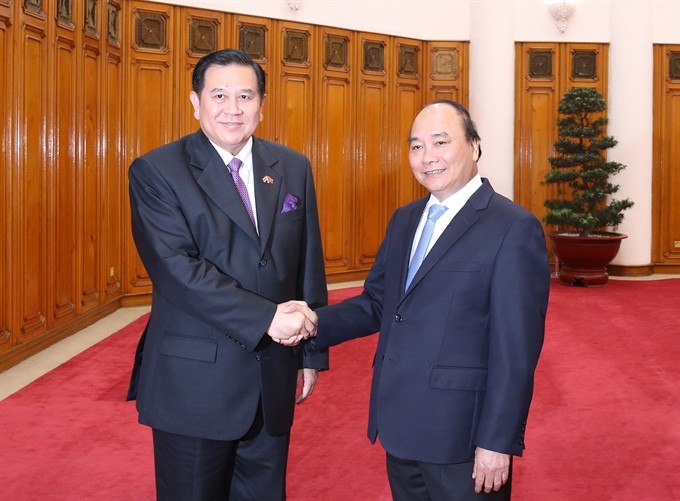 Prime Minister Nguyễn Xuân Phúc (right) receives Thai Deputy Prime Minister Thanasak Patimaprakorn in Hà Nội yesterday. — VNA/VNS Photo Thống