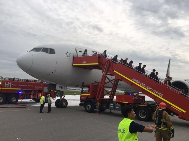 Passengers are evacuated from the plane on early June 27th, 2016.
