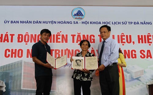 Wife and son of Sergeant Nguyen Thanh Trong being laid down in January 19th, 1974 present remembrances and materials for Paracel Exhibition House. (Photo:SGGP)