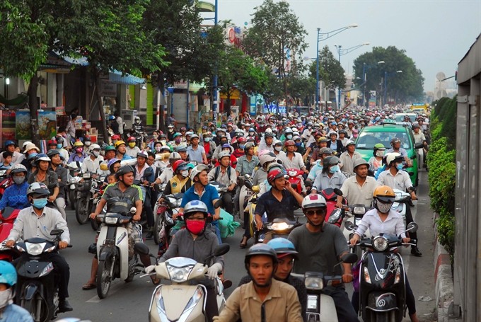 Motorbikes dominate Trường Chinh Street in HCM City. Exhaust fume inspections will be required for citizens in Hà Nội, HCM City, Hải Phòng, Đà Nẵng and Cần Thơ, whose motorbikes are 15 years or older. The motorbike exhaust fume gauge is expected to be applied on July 1, 2018. — VNA/VNS Photo Mạnh Linh