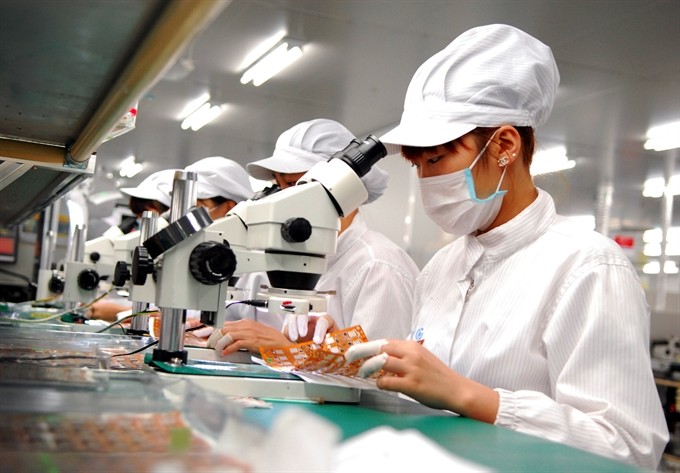 A production line for electronics spare parts at SYNOFEX Viet Nam Company in Hà Nội’s Quang Minh Industrial Park. Việt Nam is developing a comprehensive competition policy scheme to boost growth. — Photo Quang Hải