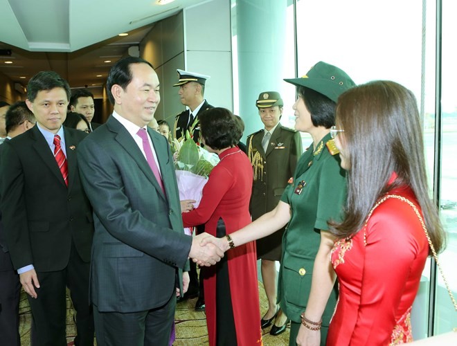 President Tran Dai Quang (L) was welcomed at Changi international airport.