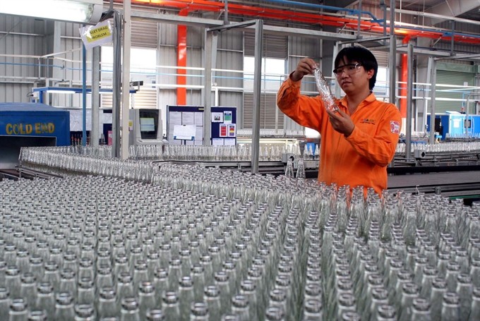 Glass bottles are manufactured at O-I BJC, a joint venture glass container manufacturer between Owens Illinois, Berli Jucker Public Company Limited and Sài Gòn Beer Alcohol Beverage Company (Sabeco). Stakes divestment from State-owned companies, including Sabeco, was urged to be implemented with transparency. (Photo: VNA/VNS)