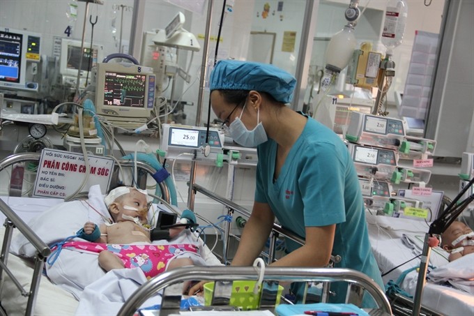 A doctor takes care of a baby in HCM City-based Children Hospital No 1. There is still a gap between policy objectives and operations in hospitals, a pilot programme on national hospital quality assessment says. — VNA/VNS Photo Chí Tưởng