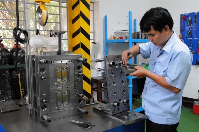 A worker completes assembling a metal product at Sài Gòn Industry Corp, one of the leading parts suppliers in HCM City. (Photo: VNA/VNS)