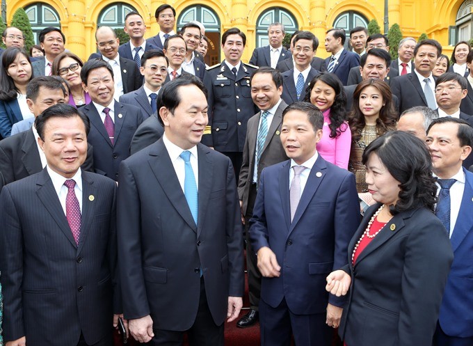 President Tran Dai Quang (second left) meets a delegation of businesses that won the National Brand Awards 2016 at the Presidential Palace in Hanoi yesterday. (Photo: VNA/VNS)