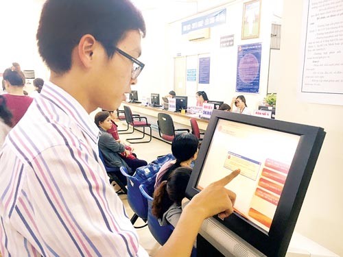 The man searches for tax information at a computer placed at the HCMC Taxation Department (Photo: SGGP)