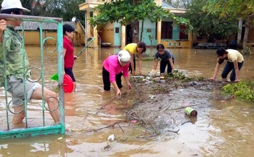 People clean the environment after flood (Photo: SGGP)