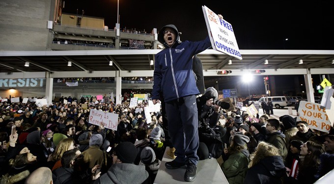 People gather for a protest at Terminal 4 of the John F. Kennedy (JFK) International Airport after people arriving from Muslim countries were held at the border control as a result of the new immigration policies enacted by US President Donald Trump in New York, on Saturday. According to reports, thousands of people took part in the demonstration as 11 people from countries on the suspension list were reportedly held at the a