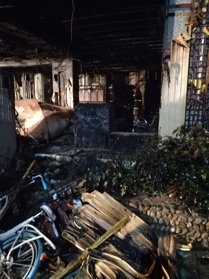 Photo taken on Monday shows the accident site after a fire broke out in the Zuxintang Foot Massage Parlor in Tiantai County, east China’s Zhejiang Province. At least 18 people have been killed and another two injured after the foot massage parlor caught fire on Sunday afternoon. — XINHUA/VNA Photo