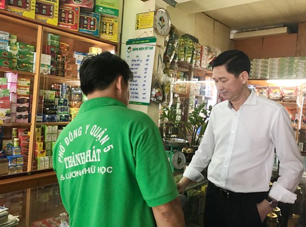 Deputy Chairman Tuyen (R) talks with people in the quarter (Photo: SGGP)