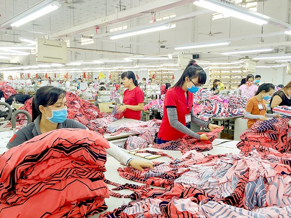 Workers of Doolim Company in Binh Chanh District in HCMC return to work after enjoying the Tet holiday in their homeland (Photo: SGGP)