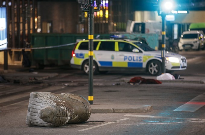 A turned over concrete traffic stopper, outside the roped off area outside the Ahlens department store after a suspected terror attack on the Drottninggatan Street in central Stockholm, Sweden, Saturday. Four people were killed and 15 injured in the suspected terror