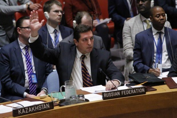 Russian Deputy Permanent Representative to the United Nations Vladimir Safronkov holds up his hand as he votes against a draft resolution that condemns the reported use of chemical weapons in Syria at the Security Council on April 12, 2017, at UN Headquarters in New York. –AFP