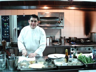 Chef Stephane Carrade prepares some food on Monday ( Photo:U.Phuong)