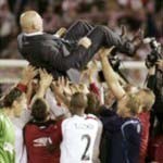 Slavia Prague's head coach Karel Jarolim is lifted up by his players after Champions League thir