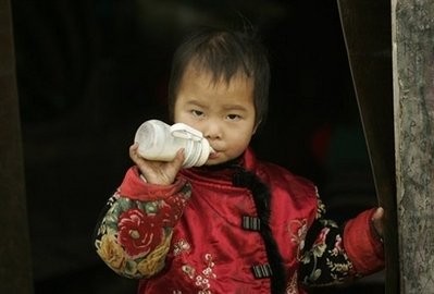 A child drinks milk in Beijing. The number of babies and infants reported sick after being fed contaminated milk powder in China jumped Saturday as the government vowed severe punishment for those responsible(AFP/Peter Parks)