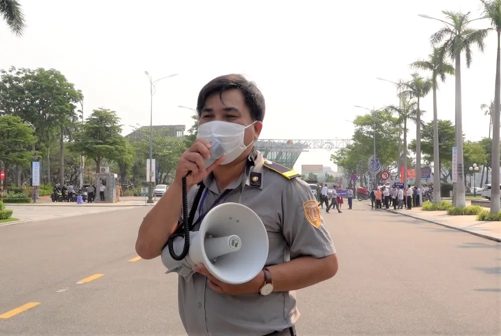 Lực lượng an ninh tòa nhà hướng dẫn nhân viên, cán bộ tòa nhà đến điểm tập kết. Ảnh: XUÂN QUỲNH Lực lượng an ninh tòa nhà hướng dẫn nhân viên, cán bộ tòa nhà đến điểm tập kết. Ảnh: XUÂN QUỲNH