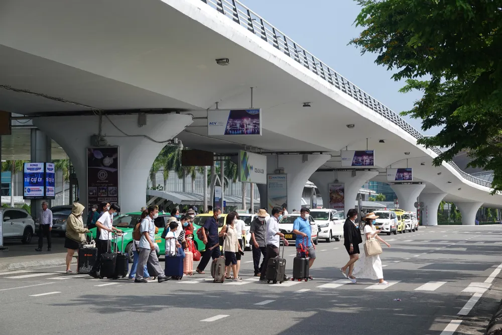 Một nhóm du khách đi ra từ sảnh quốc nội sân bay Đà Nẵng. Ảnh: XUÂN QUỲNH