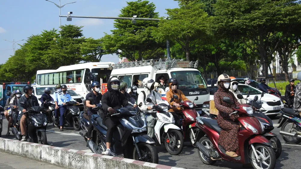 1.Vào trưa 26_6, hầu hết người dân đều phải bịt kín áo, mũ, kính râm khi tham gia giao thông dưới thời tiết hơn 30 độ C - Ảnh_ THỤC NHI.jpg
