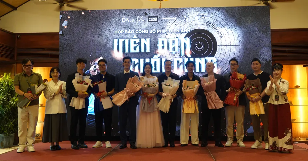 Bà Lý Phương Dung, Phó Chủ tịch Hiệp hội xúc tiến phát triển điện ảnh Việt Nam tặng hoa diễn viên, nhà sản xuất và xạ thủ Hoàng Xuân Vinh. Ảnh: XUÂN QUỲNH