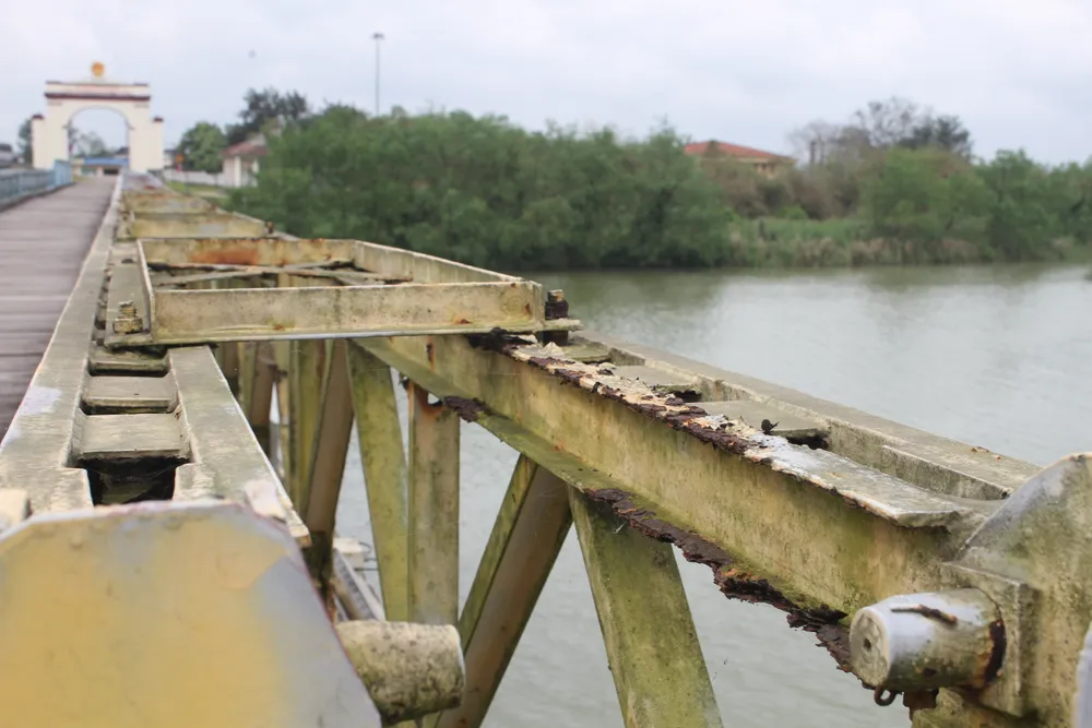 Phía trên thành cầu, nhiều bu lông, ốc vít bị rỉ sét, bong tróc. Nhiều mối hàn liên kết giữa các thanh sắt trên cầu bị bong, đặc biệt liên kết giữa thanh chống xiên và giằng đỉnh, liên kết các bệ kê gối bị rỉ sét nặng, mất khả năng chịu lực