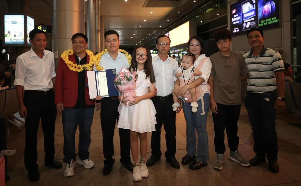Người thân cùng bạn bè đón nhà vô địch cờ tướng thế giới Lại Lý Huynh trở về nước. ẢNH: DŨNG PHƯƠNG 