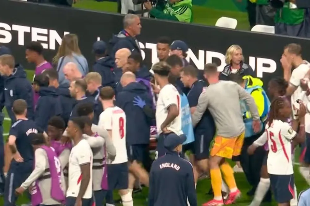 Các thành viên của tuyển Anh tập trung đưa Jordan Henderson rời khỏi sân đến thẳng bệnh viện