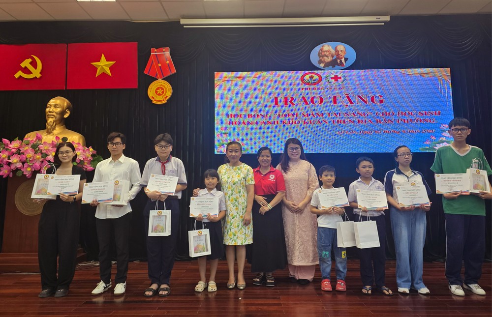 胡志明市华文教育辅助会副主席颜旭君、副主席卢美如向安乐坊华人子弟颁发助学金。