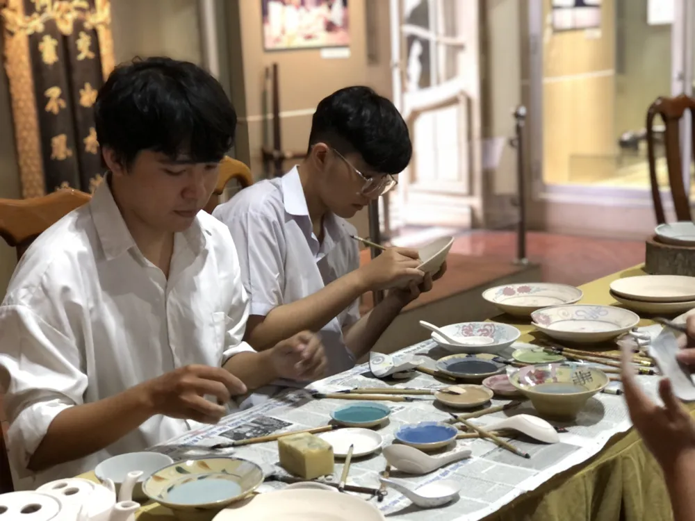 Bạn trẻ trải nghiệm trang trí cho sản phẩm gốm.